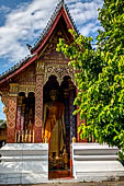 Luang Prabang, Laos - Wat Sene, a standing Buddha statue is housed inside an open pavilion. 